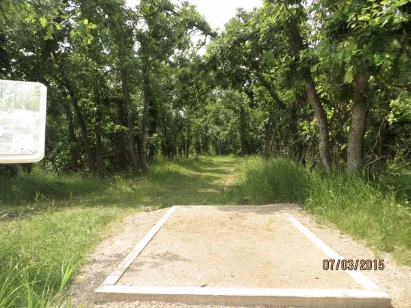 Spearfish Canyon DGC: Hole 2 · Tee pad · Jul 2015, photo by Vey Thach